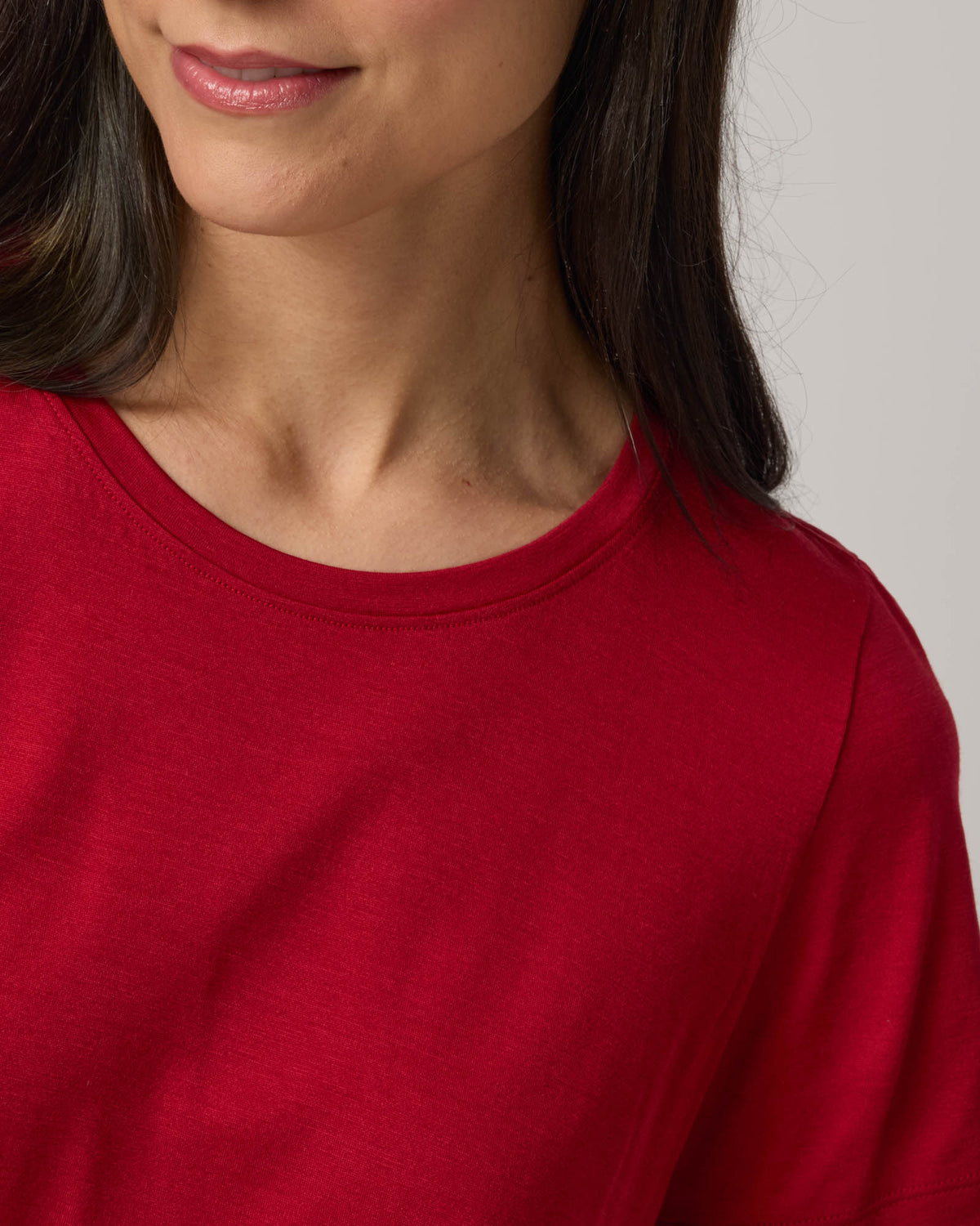 Model wearing Zoe Easy Crew Neck Tee in Cherry Red, a bright red color. Zoe Easy Crew Neck Tee is a merino wool short sleeve, crew neck, regular fit tee available in sizes XS-3X.