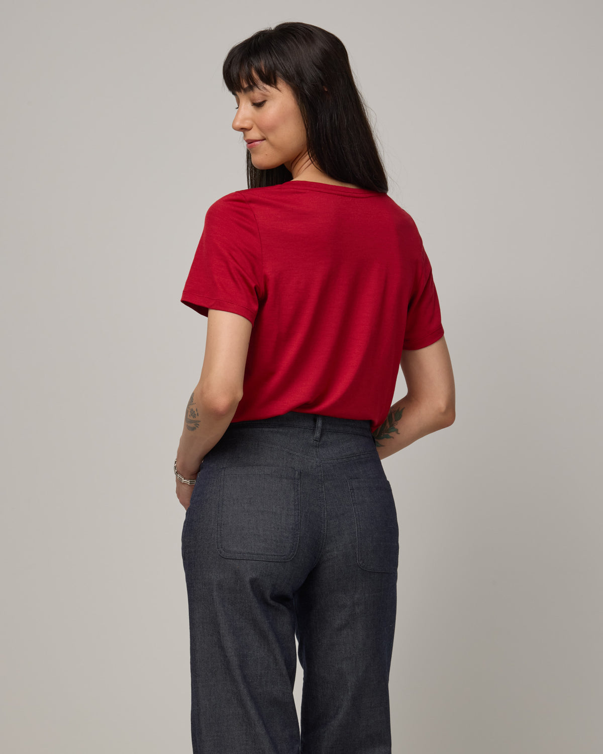 Model wearing Zoe Easy Crew Neck Tee in Cherry Red, a bright red color. Zoe Easy Crew Neck Tee is a merino wool short sleeve, crew neck, regular fit tee available in sizes XS-3X.