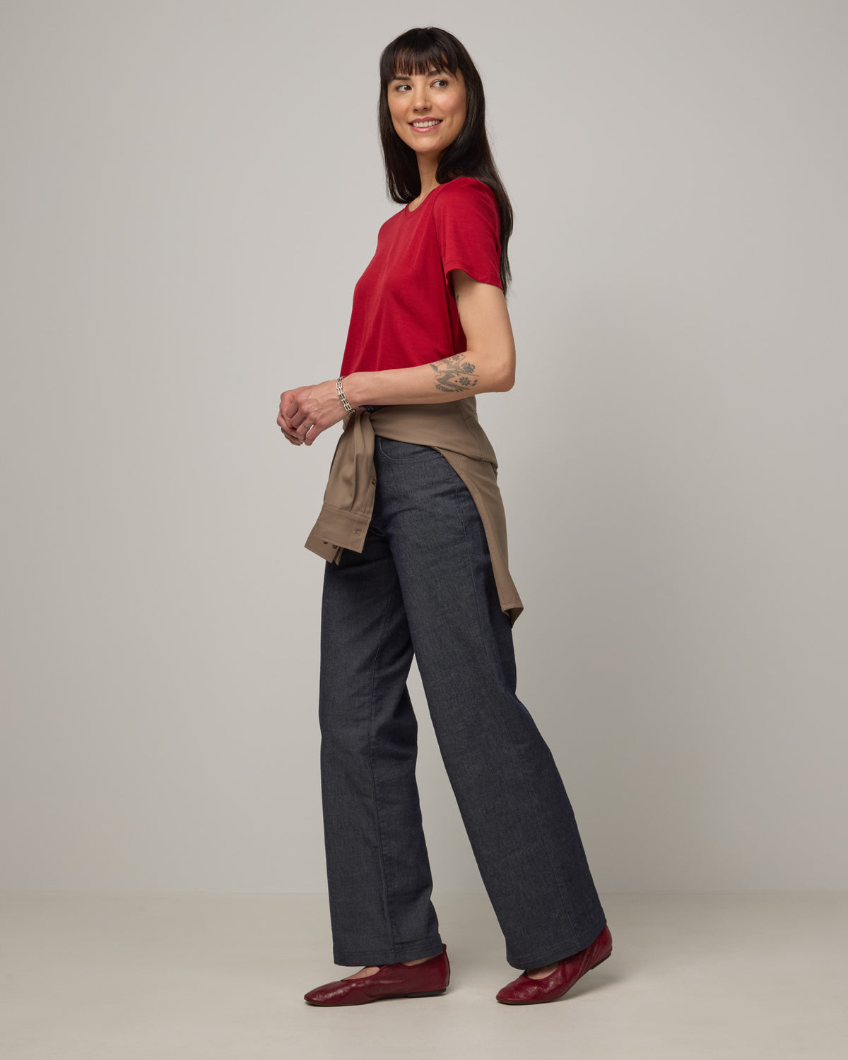 Model wearing Zoe Easy Crew Neck Tee in Cherry Red, a bright red color. Zoe Easy Crew Neck Tee is a merino wool short sleeve, crew neck, regular fit tee available in sizes XS-3X.