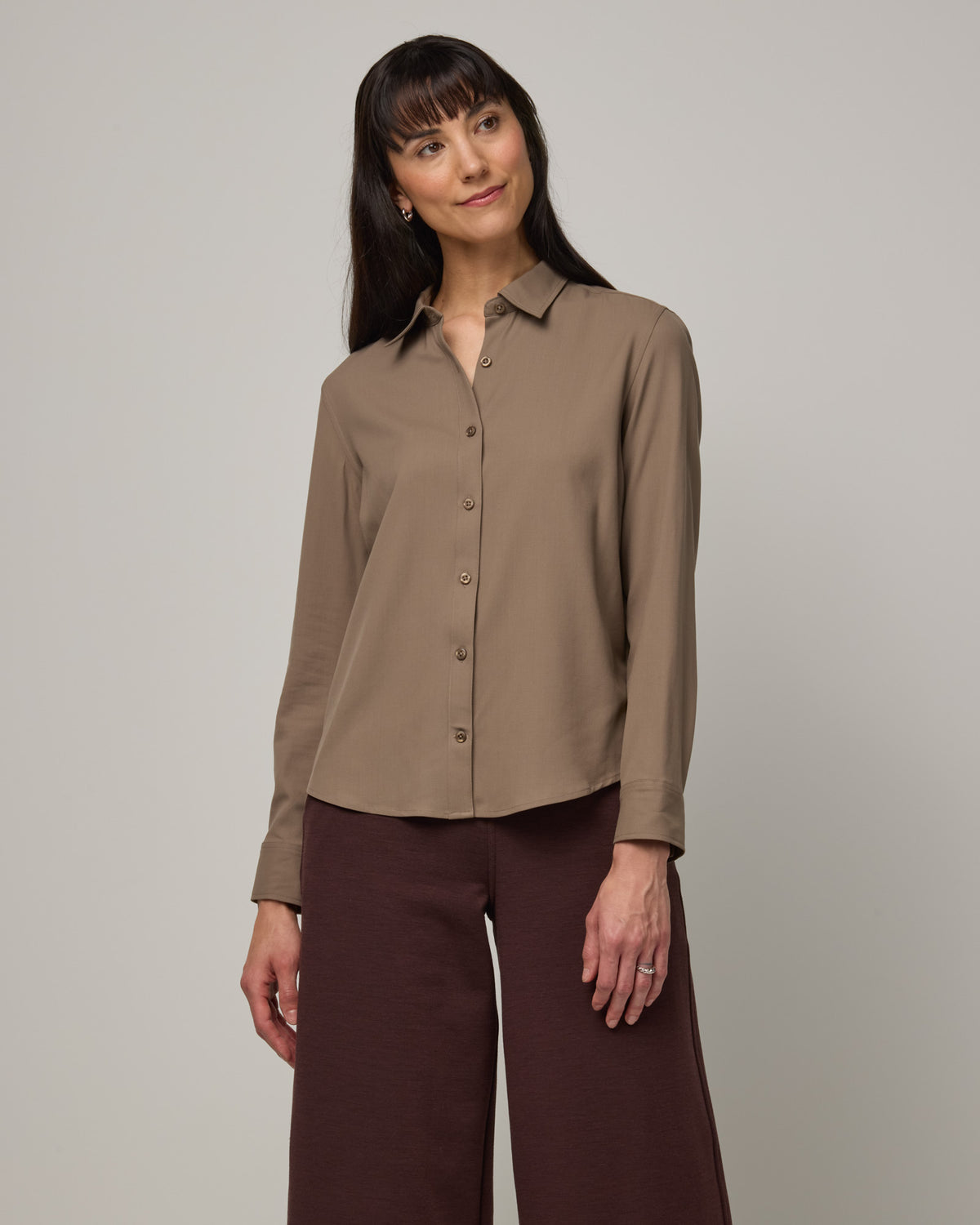 Model wearing Tiffany Button-Front Shirt in Walnut, a taupe brown color. Tiffany Button-Front Shirt is a merino wool long sleeve collared shirt available in sizes XS-XXL.