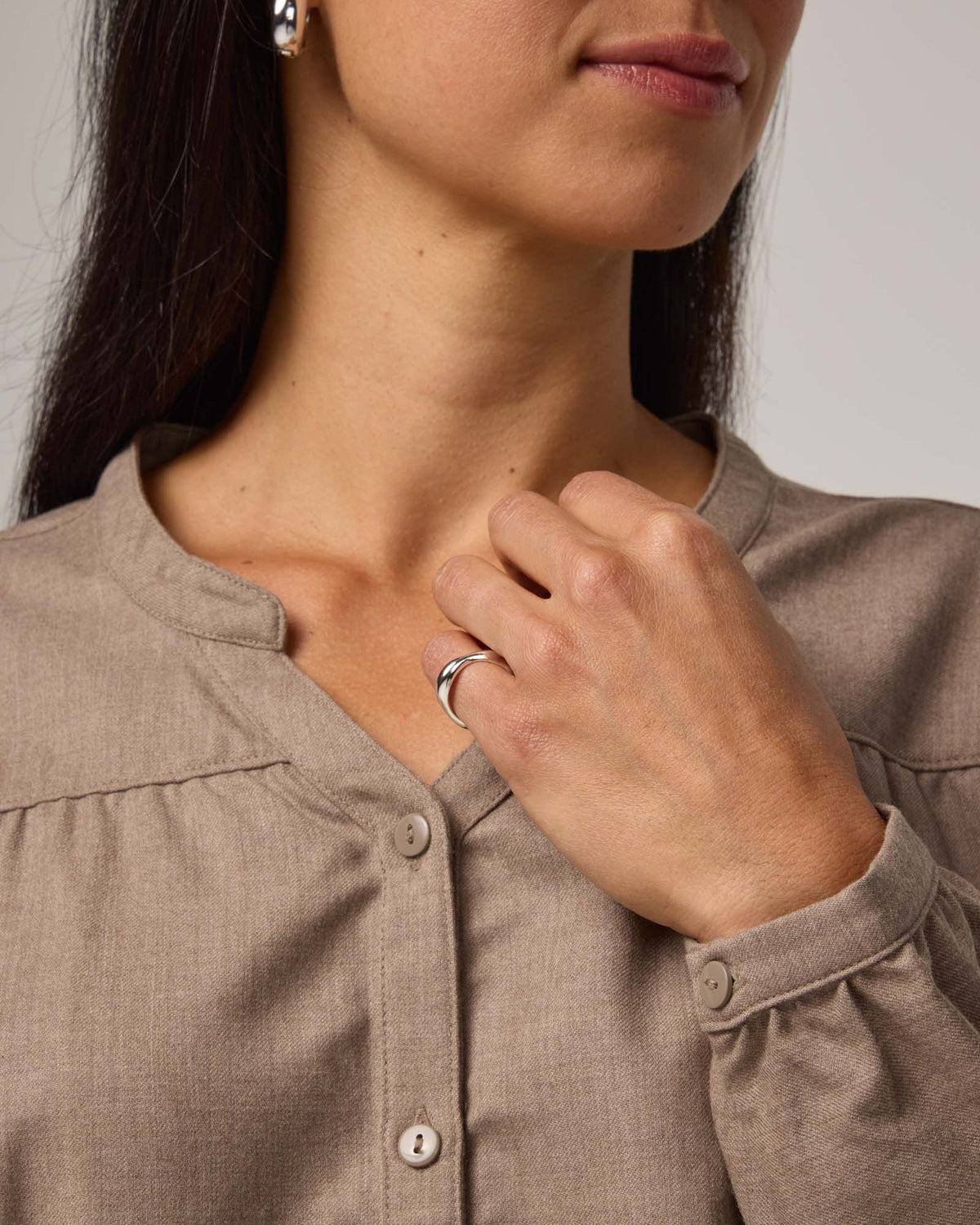 Model wearing Raquel Brushed Twill Top in Taupe Heather, a tan heathered color. Raquel Brushed Twill Top is a 100% merino wool long sleeve, split collar button-front shirt available in sizes XS-XXL.