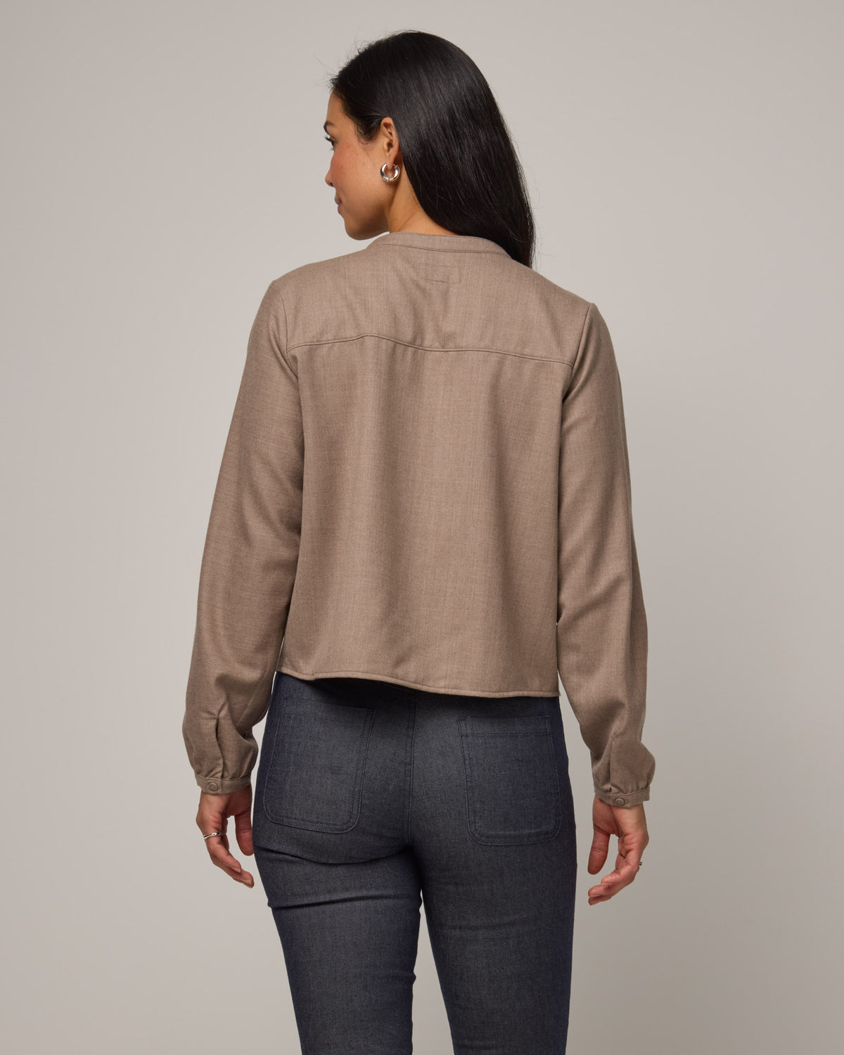 Model wearing Raquel Brushed Twill Top in Taupe Heather, a tan heathered color. Raquel Brushed Twill Top is a 100% merino wool long sleeve, split collar button-front shirt available in sizes XS-XXL.