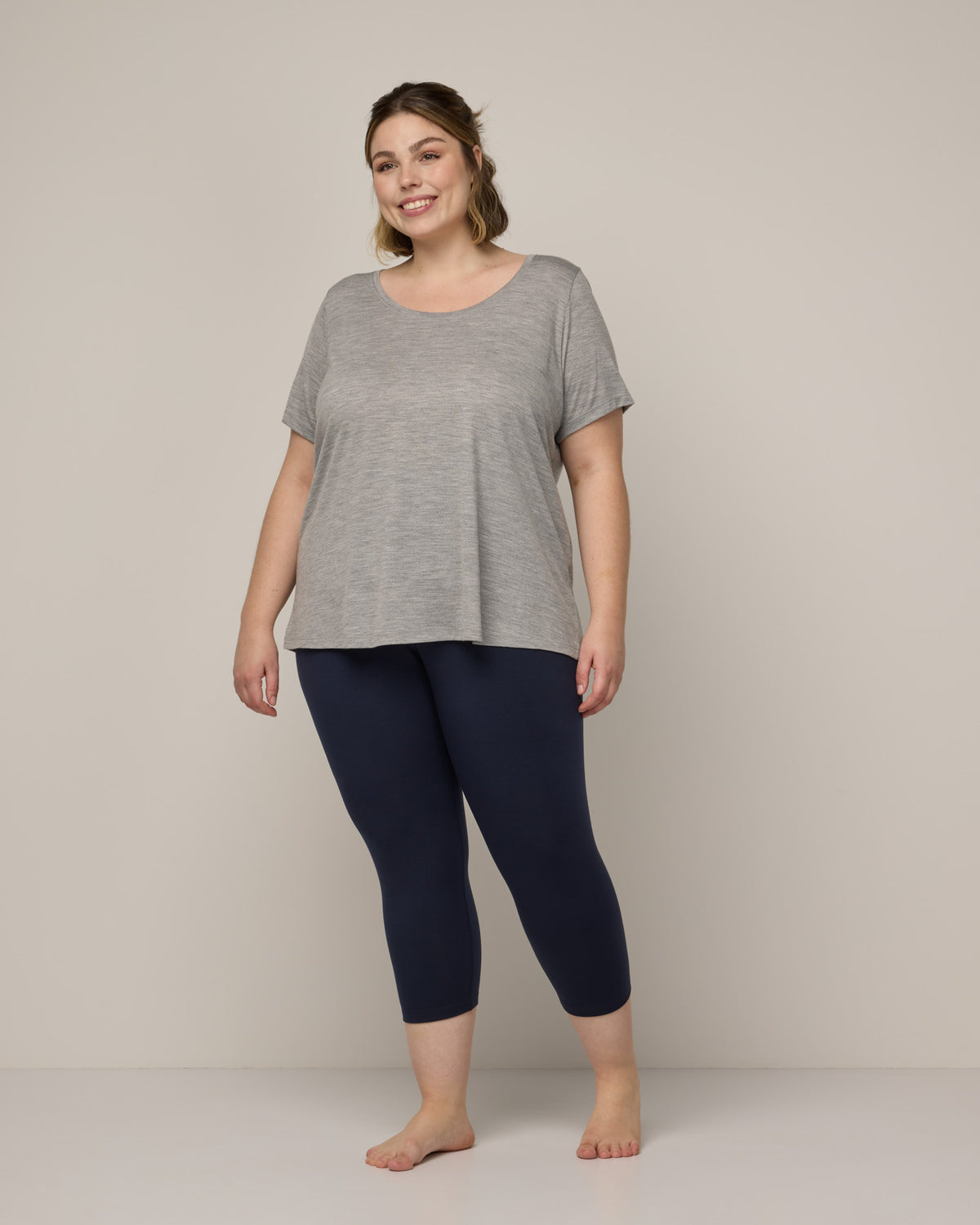 Model wearing Summit Crop Legging in Navy. Summit Crop Legging is a merino wool legging available in sizes XS-3X.